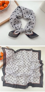 Detail of equestrian print cotton linen scarf with black rider silhouette and orange border