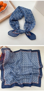 Detailed close-up of blue houndstooth cotton linen scarf with contrasting orange edges