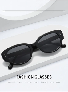 Detail view of AM210 black cat-eye sunglasses with silver dot metal accents on white stand