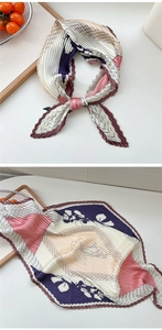 Detailansicht eines plissierten Seidenschals mit Blumenmuster und Pastellfarben