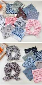 Close-up of assorted floral and cherry print cotton linen scarves in various soft colors