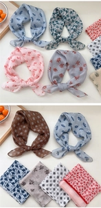 Close-up of soft breathable cotton linen scarf with cherry print and delicate hemmed edges