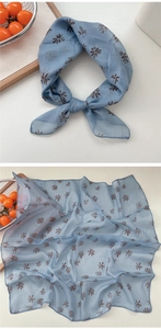 Detail of light blue floral cotton linen neck scarf with delicate brown petal pattern