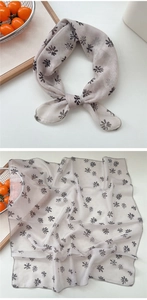 Macro view of light grey floral square scarf showing breathable fabric and fine edge stitching