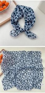 Close-up of white cotton linen scarf with navy ginkgo leaf pattern and delicate edges