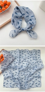 Detail of light blue printed square cotton linen scarf with abstract floral patterns