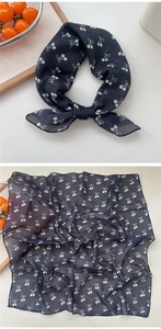 Detail of square cotton linen scarf with white cherry and bow print on black fabric