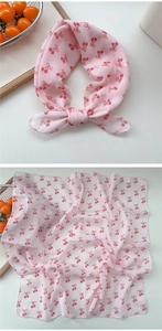 Detail of soft cotton linen square scarf with red cherry prints in light pink color