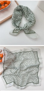 Detail of silk small square scarf with green floral pattern and fine rolled edges