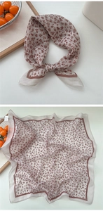 Detail of vintage floral cotton-linen square scarf with red patterns on cream fabric