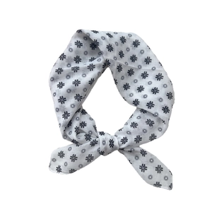Breathable cotton linen white square scarf with navy floral print tied in a bow