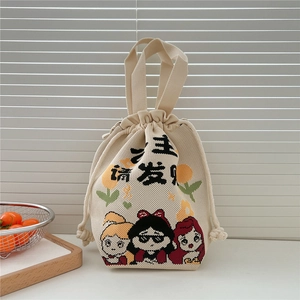 Detailed view of beige knitted drawstring bucket bag with cartoon character patterns