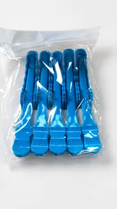 Detailed view of professional blue sectioning hair clips with non-slip grip in bulk pack