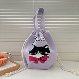 Close-up of light purple knitted drawstring bag with cat pattern and pink bow detail