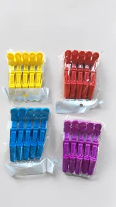 Close-up of colorful plastic hair sectioning clips in yellow, red, blue and purple tones