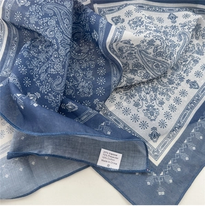 Detail of blue and white paisley square scarf showing soft breathable cotton blend fabric