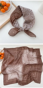 Detail view of cotton-linen square scarf with paisley patterns in brown and beige