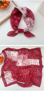 Detail of red and cream paisley square scarf with cotton linen texture and blue borders