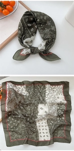 Detail view of cotton-linen square scarf with olive green paisley pattern and red edges