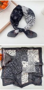 Close-up of black and white paisley pattern scarf with soft texture and delicate hemmed edges