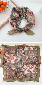 Detailed macro view showing paisley print cotton linen scarf with hand-rolled edges