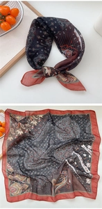 Detail of paisley square scarf with navy blue and ochre red patterns in soft chiffon