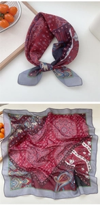 Detailed view of paisley silk scarf with red and grey mandala patterns and hand-rolled edges