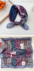 Detailed view of square paisley silk scarf with purple and navy geometric patterns