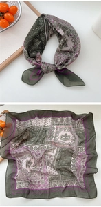 Detail of breathable paisley cotton linen scarf with soft floral patterns and translucent texture