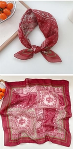 Detail view of a soft red paisley cotton linen square scarf with bohemian print details