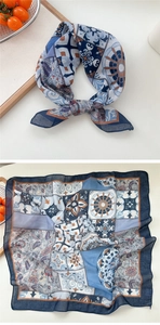 Detail of blue and orange paisley square scarf with vintage floral patterns and soft texture