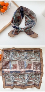 Close-up of a floral cotton square scarf with earth tones and geometric patterns