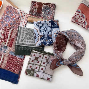 Floral and paisley printed small square scarves in a variety of vibrant colors