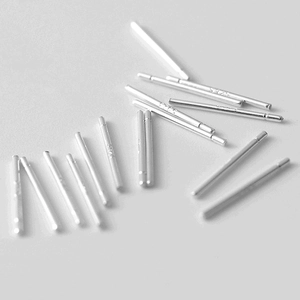 Multiple 925 sterling silver ear pins for DIY jewelry making on grey surface