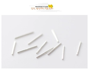 Macro shot of minimalist S925 sterling silver straight bar earrings on white background