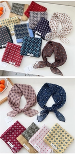 Close-up of assorted vintage cotton linen scarves with diverse retro floral patterns