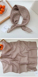 Detail of brown polka dot square scarf with silk texture and fine stitched edges