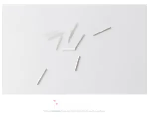 Macro shot of minimalist silver straight ear studs with a smooth metallic finish