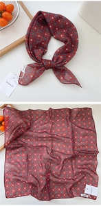 Macro detail of red floral cotton linen small square scarf with delicate stitching
