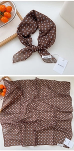 Detail of brown cotton linen scarf with geometric floral print and premium brand tag