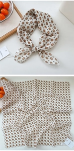 Detailed flat lay of a cotton-linen scarf with vintage geometric patterns and soft textures