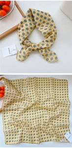 Detailed view of yellow linen-cotton scarf with blue geometric floral patterns