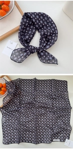 Close-up of square cotton-linen scarf with navy geometric floral print and neat hem