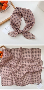 Detail of vintage pink cotton linen scarf with blue floral patterns and neat hem edges