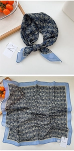 Detail of blue and gold baroque pattern silk scarf showing knotting and flat layout
