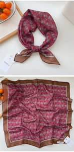Detail of burgundy floral linen scarf with vintage patterns and branded tag