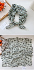 Detailed macro view of a retro geometric polka dot silk scarf with light blue and yellow patterns