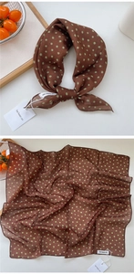 Detail of vintage brown square scarf with green polka dots and a lightweight texture