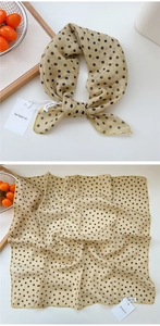 Macro detail of beige polka dot silk scarf showing fine fabric texture and yellow hem