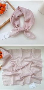 Macro detail of pink polka dot cotton-linen scarf showing fine stitching and fabric texture
